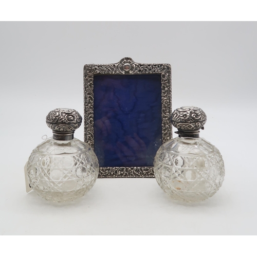 368 - A pair of silver topped scent cut crystal bottles, by Walker & Birmingham, of spherical form, an... 