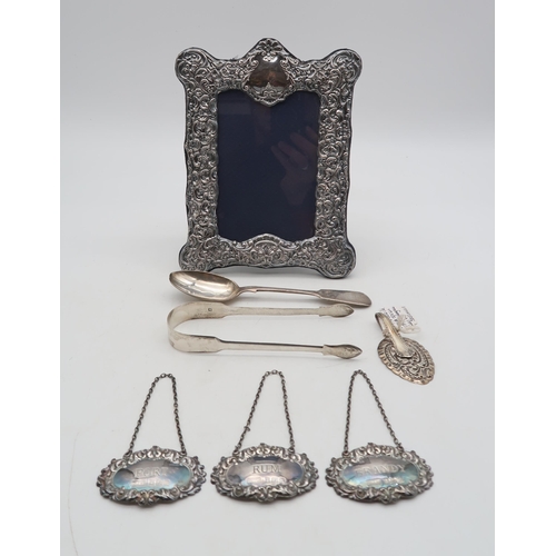 370 - A collection of silver including a pair of George III silver sugar tongs, London 1810?, maker's mark... 