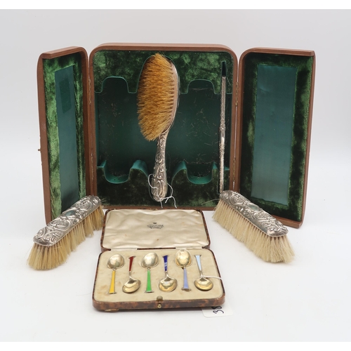 383 - A cased late Victorian four piece dressing table set, Birmingham 1898, with scrolling foliate decora... 