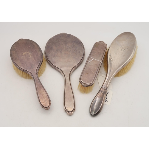 386 - A three piece silver dressing set, by Adie Brothers ltd, Birmingham 1957, and another silver hair br... 