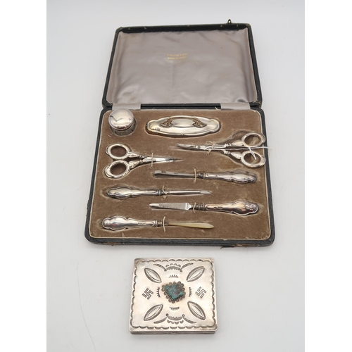 402 - A cased silver stainless steel manicure set, by Samuel M Levi, Birmingham, and a Navajo white metal ... 