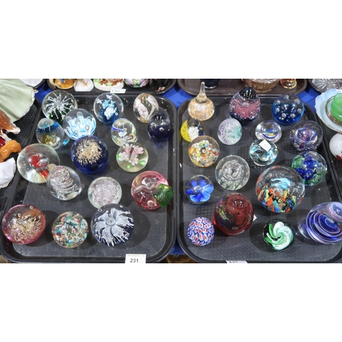 231 - A collection of glass paperweights including Caithness, Mdina and assorted others