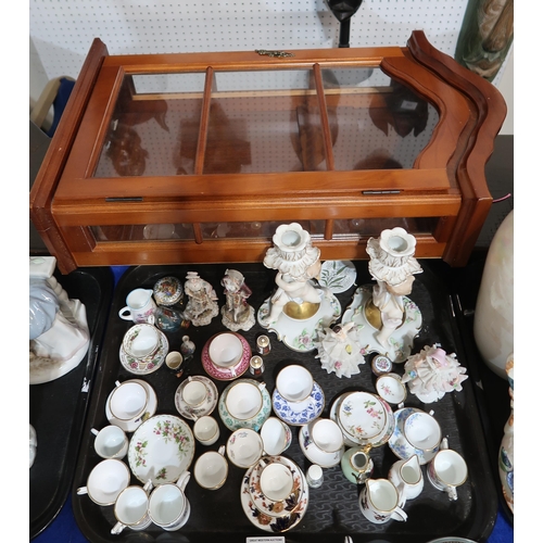 247 - A collection of miniature cups and saucers, Dresden style figures etc and a display case