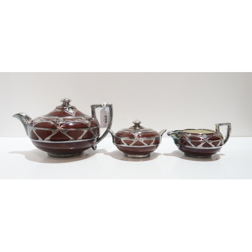 259 - A brown glazed Wedgwood teaset with silver overlay decoration