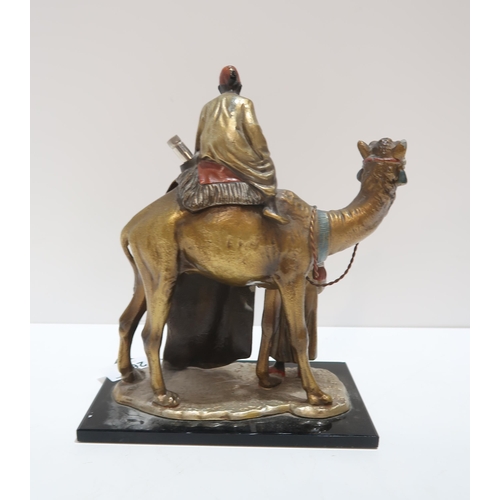 265 - A cold painted table striker, modelled as two carpet sellers and a camel, in the style of Franz Berg... 