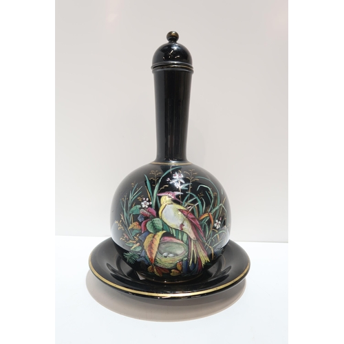 268 - A Victorian bottle vase, with stand and lid,  painted in enamels with a bird in a tree with but... 