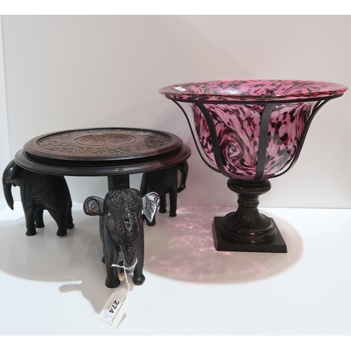 274 - A pink, white and black glass dish in stand, together with a carved table top table with elephant le... 