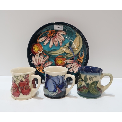 287 - A Moorcroft Mayfly pattern plate, 25.5cm diameter together with three Moorcroft mugs in Fruit Garden... 