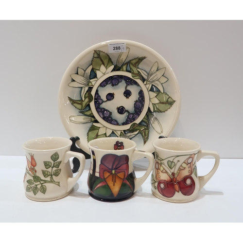 288 - A Moorcroft Juneberry pattern plate, 25.5cm diameter together with three Moorcroft mugs in Rosehips,... 