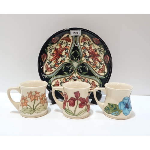 289 - A Moorcroft Honeysuckle pattern plate, 25.5cm diameter together with three Moorcroft mugs decorated ... 