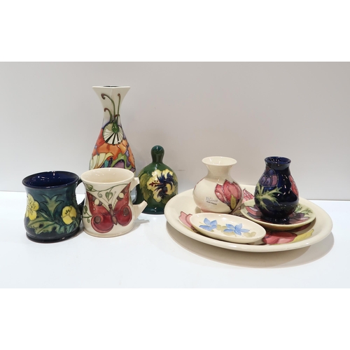 295 - A collection of Moorcroft pottery including a MCC 2008 vase, a hibiscus bell, two mugs, a anemone va... 