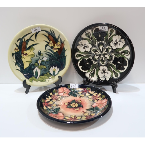 296 - Three Moorcroft plates in Bullrushes, Black and White pansy and Oberon patterns, all 25.5cm diameter