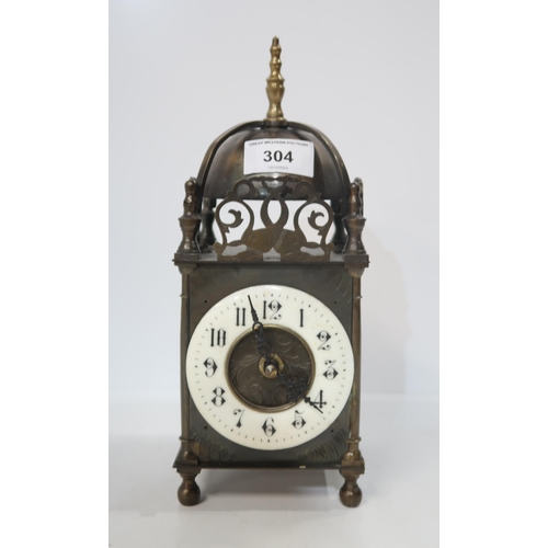 304 - A Brass electric lantern clock with enamel ring dial