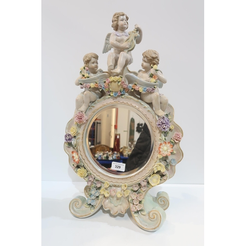 329 - A continental cherub mounted mirror