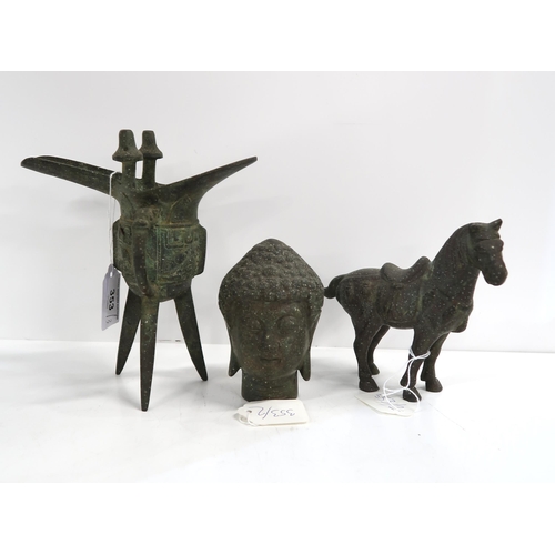 353 - An antique style Chinese wine vessel on three legs, a Buddha head and a model of a horse