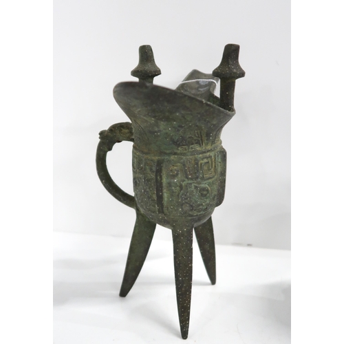 353 - An antique style Chinese wine vessel on three legs, a Buddha head and a model of a horse