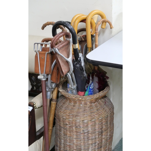 137 - A large mixed lot of assorted wicker baskets, shooting sticks, umbrellas etc