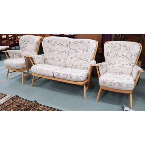 69 - A 20th century elm and beech Ercol three piece suite comprising two seater rail back settee, 93cm hi... 