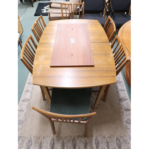 76 - A mid 20th century teak Vanson dining suite comprising extending dining table on shaped tapering sup... 