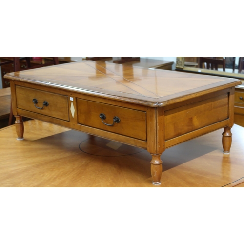 82 - A late 20th century French cherrywood Artcopi coffee table with shaped rectangular top over two stra... 