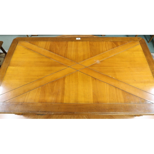 82 - A late 20th century French cherrywood Artcopi coffee table with shaped rectangular top over two stra... 