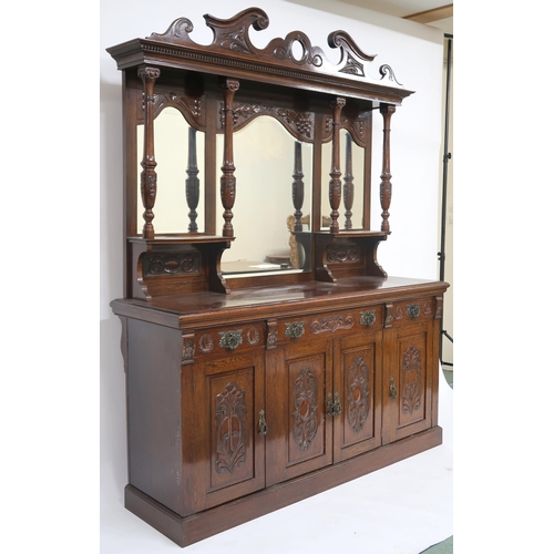 25 - A LATE VICTORIAN STAINED OAK ARTS & CRAFTS MIRROR BACKED SIDEBOARD with scrolled surmount o... 