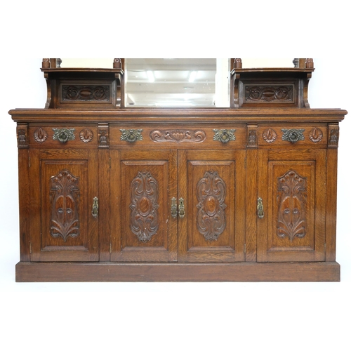 25 - A LATE VICTORIAN STAINED OAK ARTS & CRAFTS MIRROR BACKED SIDEBOARD with scrolled surmount o... 