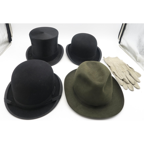 523 - A selection of gentleman's hats, comprising a boxed silk top hat by Moss Bros., two bowlers (one by ... 