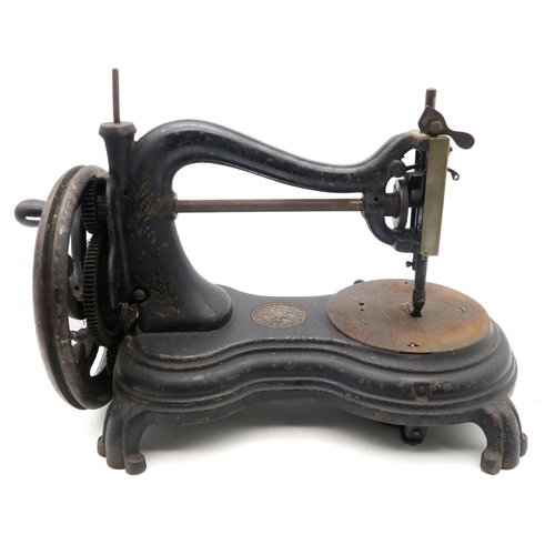 566 - A Victorian Serpentine, Swan Neck or Cat Back hand-crank sewing machine by Jones & Co. of Manche... 