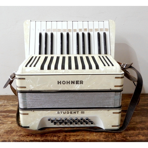 451 - A Hohner Student III 24 bass 25 key piano accordion in faux mother of pearl, with original case.