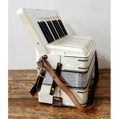 451 - A Hohner Student III 24 bass 25 key piano accordion in faux mother of pearl, with original case.