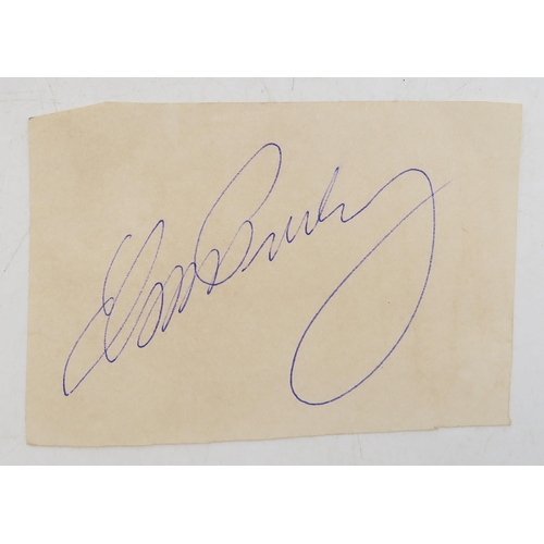 572A - Elvis Presley: an autograph, signed in blue ink on paper, measuring approx. 9cm x 6.4cm