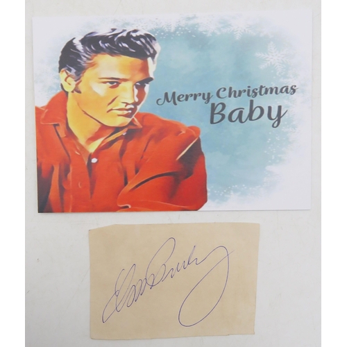 572A - Elvis Presley: an autograph, signed in blue ink on paper, measuring approx. 9cm x 6.4cm