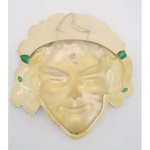 2160 - A CLARICE CLIFF FLORA WALL MASK circa 1936, relief moulded as a lady's face with floral hairband in ... 