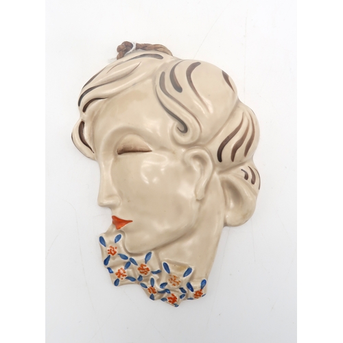 2161 - A CLARICE CLIFF WALL MASKcirca 1936, moulded as a lady in profile with blue and orange flowers aroun... 