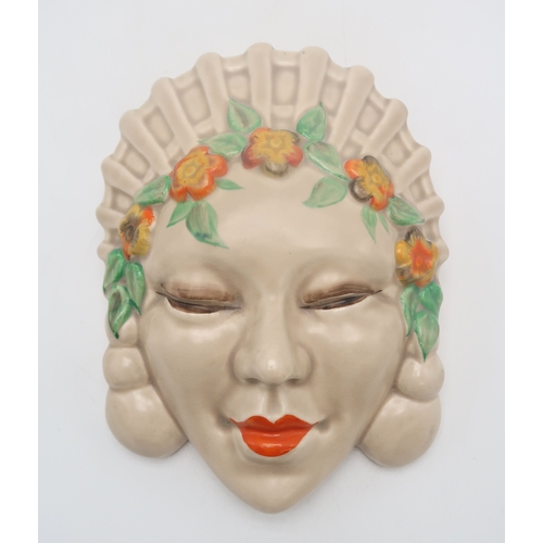2163 - A CLARICE CLIFF MASK WALL POCKETcirca 1936, moulded as a lady's head with orange and yellow flower h... 
