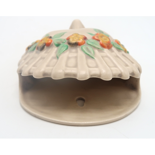 2163 - A CLARICE CLIFF MASK WALL POCKETcirca 1936, moulded as a lady's head with orange and yellow flower h... 