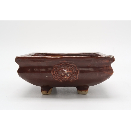 2352 - A CHINESE AUBERGINE GLAZED SQUARE CENSERThe shoulder applied with a pair of animal mask handles, abo... 