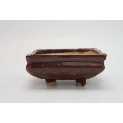 2352 - A CHINESE AUBERGINE GLAZED SQUARE CENSERThe shoulder applied with a pair of animal mask handles, abo... 