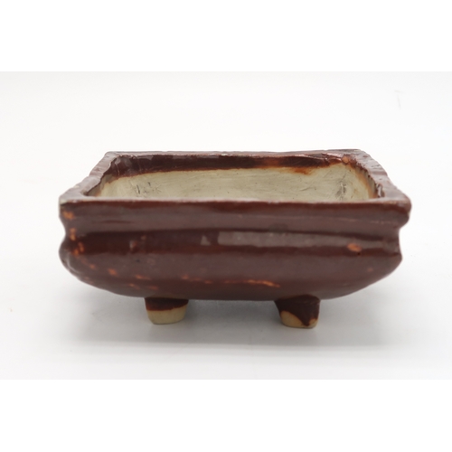 2352 - A CHINESE AUBERGINE GLAZED SQUARE CENSERThe shoulder applied with a pair of animal mask handles, abo... 