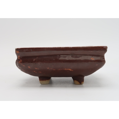 2352 - A CHINESE AUBERGINE GLAZED SQUARE CENSERThe shoulder applied with a pair of animal mask handles, abo... 