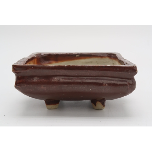 2352 - A CHINESE AUBERGINE GLAZED SQUARE CENSERThe shoulder applied with a pair of animal mask handles, abo... 