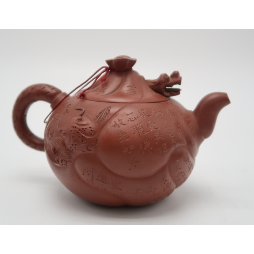 2355 - A YIXING TEAPOT AND COVERWith articulated dragon cover above calligraphy, fish and dragon, 16cm wide... 