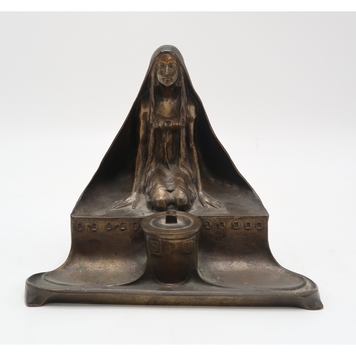2174 - A CONTINENTAL ART NOUVEAU BRONZE INKWELL AND PEN TRAYmodelled as a kneeling maiden wearing a cloak, ... 