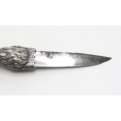 2600 - AN UNUSUAL WHITE METAL SGIAN DUBH The grip hand-chased and modelled as an eagle's claw gripping a ye... 