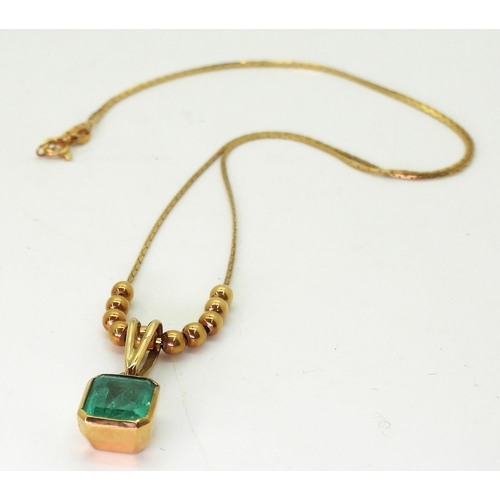 776 - An emerald pendant and chain with bead detail. The step cut emerald is approx 7.7mm x 7.5mm x 4.3mm,... 