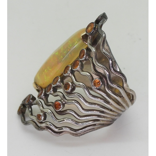 777 - A yellow and white metal handmade bespoke designer ring, set with a large colourful jelly opal and o... 