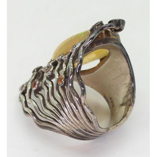 777 - A yellow and white metal handmade bespoke designer ring, set with a large colourful jelly opal and o... 