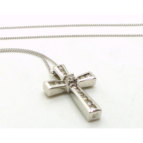 781 - A 9ct white gold cross and chain set with estimated approx 0.25cts of brilliant cut diamonds, weight... 