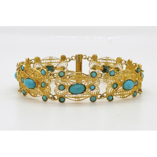 2701 - A FILIGREE AND TURQUOISE BRACELETmade in bright yellow metal stamped with Arabic marks verso and 750... 